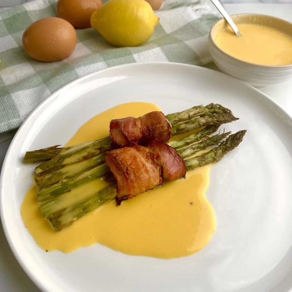Bacon Wrapped Asparagus with Hollandaise on plate