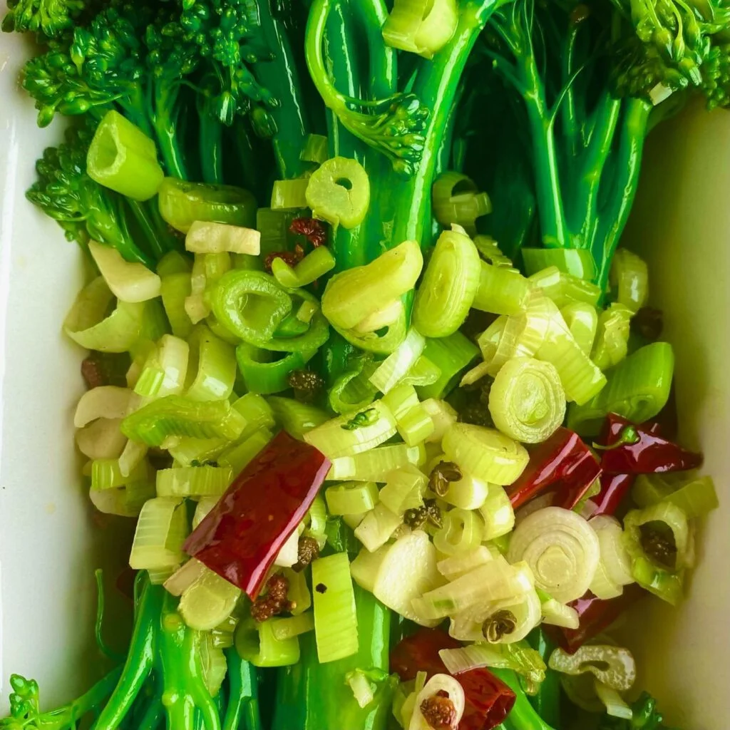 Garlic, Chili, Peppercorns and Scallions topping Broccolini