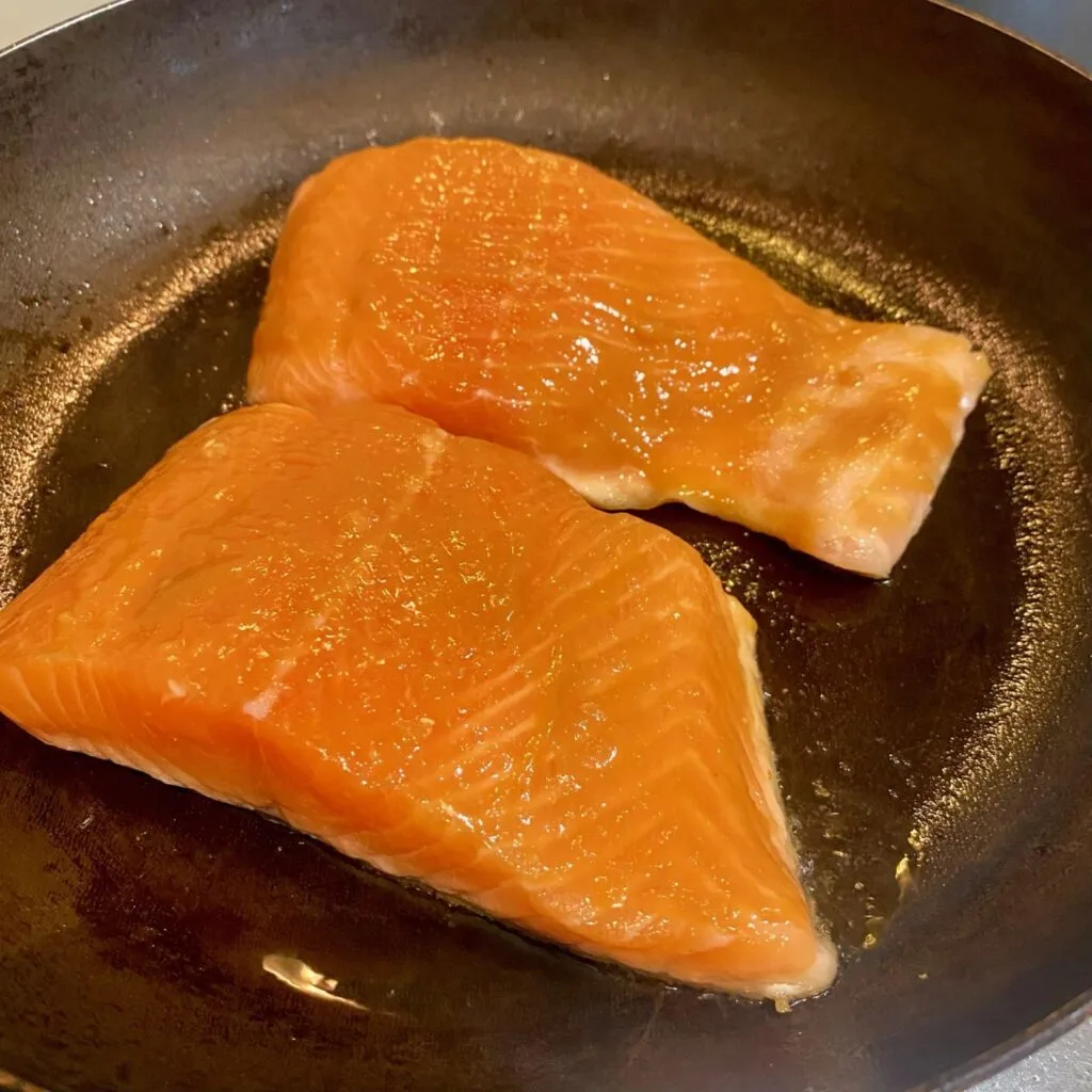 Salmon being Glazed in Pan