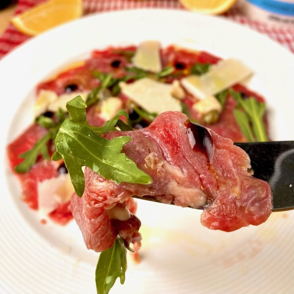 Thin slices of Beef on fork
